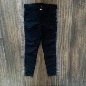 Stretchy black pants with ball chain fringe.